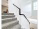 Carpeted stairs with dark wood railing and white walls at 13651 Eridanus Dr, Orlando, FL 32828