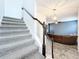 Modern staircase with gray carpet and dark wood railing at 13651 Eridanus Dr, Orlando, FL 32828