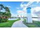 Paved path winds to a bridge, lighthouse, and lake; lush landscaping at 1401 W Highway 50 # 68, Clermont, FL 34711