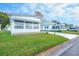 White mobile home with carport and landscaped lawn at 1401 W Highway 50 # 68, Clermont, FL 34711