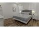 Main bedroom with a king-size bed and wood floors at 1472 Fairview Cir, Reunion, FL 34747