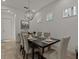 Dining area with dark wood table and six chairs, globe light fixture at 1472 Fairview Cir, Reunion, FL 34747