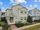 Two-story house with light green siding, brick walkway, and landscaping at 1472 Fairview Cir, Reunion, FL 34747