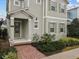 Front entrance with green door and brick walkway at 1472 Fairview Cir, Reunion, FL 34747