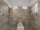 Large walk-in shower with glass enclosure and built-in seat at 1472 Fairview Cir, Reunion, FL 34747