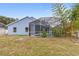 View of the house from the backyard, highlighting the pool at 148 Imperial Oak Ct, Davenport, FL 33896