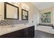 Main bathroom with double vanity, soaking tub, and gray tile flooring at 148 Imperial Oak Ct, Davenport, FL 33896