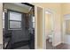 Bathroom with dark-tiled shower, white toilet, and gray floor tiles at 148 Imperial Oak Ct, Davenport, FL 33896