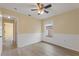 Bedroom with vinyl plank flooring, ceiling fan, and wainscoting at 148 Imperial Oak Ct, Davenport, FL 33896