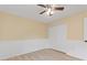 Bright bedroom with ceiling fan, double door closet, and wood-look flooring at 148 Imperial Oak Ct, Davenport, FL 33896