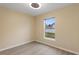 Well-lit bedroom featuring a window with backyard view and wood-look vinyl flooring at 148 Imperial Oak Ct, Davenport, FL 33896