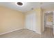 Spacious bedroom with double door closet and access to hallway at 148 Imperial Oak Ct, Davenport, FL 33896