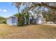 Front view of light blue house with landscaping and driveway at 148 Imperial Oak Ct, Davenport, FL 33896