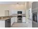 Modern kitchen with granite countertops and white cabinets at 148 Imperial Oak Ct, Davenport, FL 33896