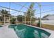 Pool area with screened enclosure and backyard view at 148 Imperial Oak Ct, Davenport, FL 33896