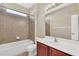 Bathroom with tub, shower, and wood vanity at 1580 Prairie Oaks Dr, St Cloud, FL 34771