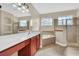 Main bathroom with soaking tub, shower, and stained glass window at 1580 Prairie Oaks Dr, St Cloud, FL 34771