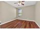 Bright bedroom with wood-look floors and ceiling fan at 1580 Prairie Oaks Dr, St Cloud, FL 34771