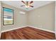 Bedroom with wood-look floors and ceiling fan at 1580 Prairie Oaks Dr, St Cloud, FL 34771