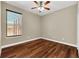 Spacious bedroom with wood-look floors and ceiling fan at 1580 Prairie Oaks Dr, St Cloud, FL 34771