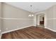 Formal dining room with hardwood floors and a view into the kitchen at 1580 Prairie Oaks Dr, St Cloud, FL 34771