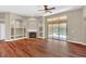 Living room with fireplace, built-in shelving, and sliding doors to the pool at 1580 Prairie Oaks Dr, St Cloud, FL 34771