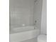 Simple bathroom with a large bathtub and tile surround at 1603 Gardiner St, Haines City, FL 33844