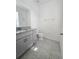 Clean bathroom, granite countertop, gray cabinets, tile floor at 1603 Gardiner St, Haines City, FL 33844