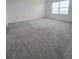 Large bedroom with plush carpeting and a window with blinds at 1603 Gardiner St, Haines City, FL 33844