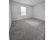 Bright bedroom featuring carpeted floors and a window at 1603 Gardiner St, Haines City, FL 33844