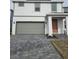 Two-story home with gray garage door and orange front door at 1603 Gardiner St, Haines City, FL 33844