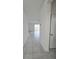 Bright hallway with tile flooring leading to living area at 1603 Gardiner St, Haines City, FL 33844