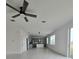 Open living space with kitchen view and ceiling fan at 1603 Gardiner St, Haines City, FL 33844