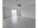 Spacious living room with tile floors and sliding glass doors at 1603 Gardiner St, Haines City, FL 33844