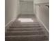 Carpeted staircase leading to the upper level at 1603 Gardiner St, Haines City, FL 33844