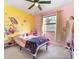 Bright bedroom with a twin bed, colorful decor, and ample natural light at 16036 3Rd St, Umatilla, FL 32784