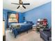 Bedroom with blue walls, ceiling fan and plenty of closet space at 16036 3Rd St, Umatilla, FL 32784