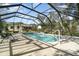 Inviting swimming pool with a screened enclosure and plenty of space for lounging at 16036 3Rd St, Umatilla, FL 32784