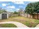 Landscaped backyard with storage shed and brick walkway at 1718 Errol Woods Dr, Apopka, FL 32712