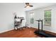 Bedroom with hardwood floors, desk, and treadmill at 1718 Errol Woods Dr, Apopka, FL 32712