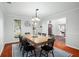 Dining room with wood table, black chairs, and a view of the entryway at 1718 Errol Woods Dr, Apopka, FL 32712