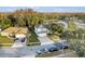 Aerial view of home with mature landscaping and pond in the background at 1727 Wood Violet Dr, Orlando, FL 32824