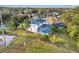 A view of a backyard with a screened in pool, mature landscaping, and a fence at 1727 Wood Violet Dr, Orlando, FL 32824