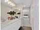 Bright bathroom featuring a double vanity, hardwood floors, and a doorway to the main bedroom at 1727 Wood Violet Dr, Orlando, FL 32824