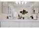 Bright bathroom with double vanity, quartz countertops and modern lighting at 1727 Wood Violet Dr, Orlando, FL 32824