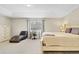 Neutral bedroom with a tray ceiling, large window, plush carpet, and contemporary furnishings at 1727 Wood Violet Dr, Orlando, FL 32824
