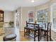 Cozy dining area with a dark wood table, bench seating, and views to the outdoor living space at 1727 Wood Violet Dr, Orlando, FL 32824