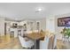 Open concept dining room with a view of the kitchen and living room at 1727 Wood Violet Dr, Orlando, FL 32824