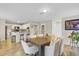 Large dining area connects to a kitchen with a breakfast bar for additional seating and convenience at 1727 Wood Violet Dr, Orlando, FL 32824