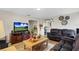 Spacious living room featuring a large television and an adjacent entryway at 1727 Wood Violet Dr, Orlando, FL 32824